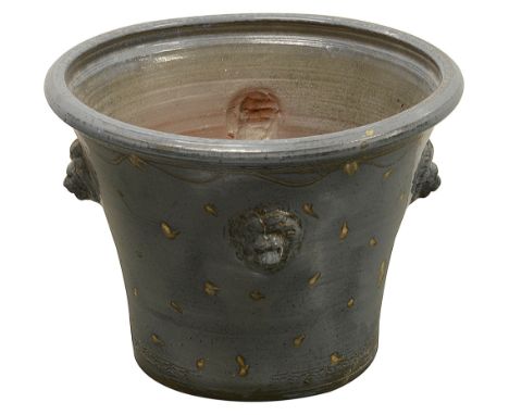 A large modern terracotta planterblue glazed and of circular tapered form, with four lion masks and speckled decoration, with