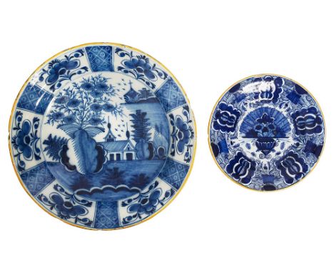 An 18th century Dutch Delft blue and white charger and a 'Peacock' platefirst Blompot factory, painted with a chinoiserie lan