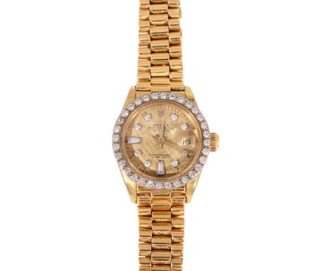 A lady's 18K yellow gold and diamond Rolex Oyster Perpetual Datethe engine turned gold coloured dial with diamond indices and