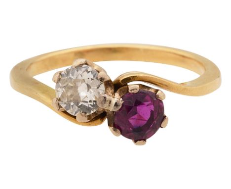 A ruby and diamond cross over ringthe old brilliant-cut diamond and the circular mixed-cut ruby obliquely-set to the plain ta