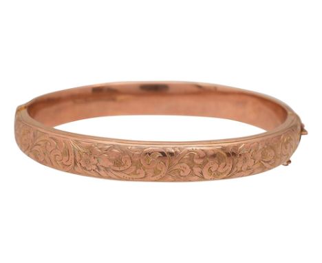 A 9ct gold hinged banglemarked '9.375' chased with scrolling floral and foliate design to one half and safety chain approx we