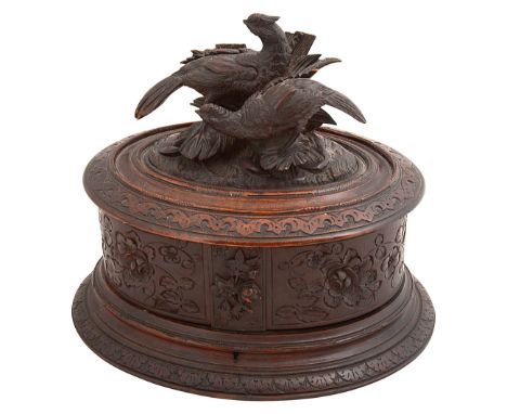 A late 19th century Swiss Black Forest oval jewellery caskethaving hinged lid carved with cock and hen pheasant finial and sw