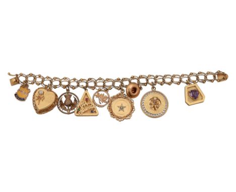 A fancy link charm bracelet marked to clasp '14k' suspending various charms including one 9ct gold and enamel 'Paisley' shiel