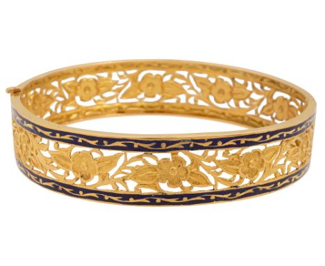 An open-work enamelled-decorated hinged bangleof pierced floral and foliate engraved decoration  and with a band of blue enam