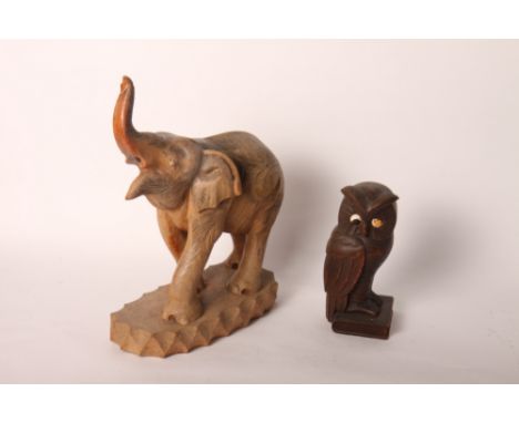 A carved wood figure of an elephant, 12" high, and a wooden clock case carved as an owl on a book