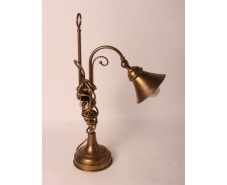 A brass desk lamp with ring handle