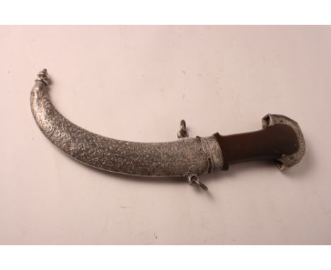 An Indian Jambiyya dagger with wooden handle and silver mounts and scabbard, blade 8" long