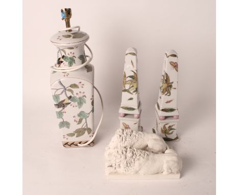 A pair of cast resin models of "Landseer" lions, a pair of ceramic obelisks decorated birds and flowers and a matching table 