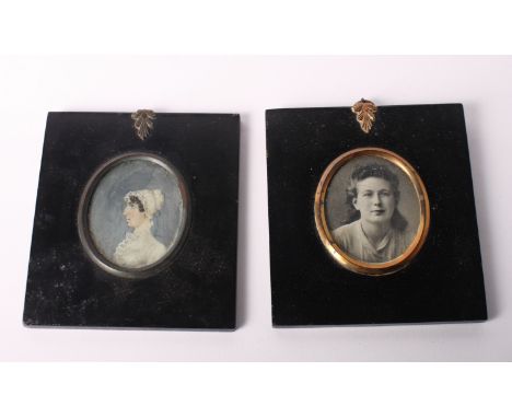 An oval miniature portrait on ivory, lady in white lace dress and bonnet, 2 3/4" x 2 1/4", in ebonised wood frame, and a matc