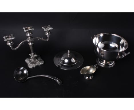 A plated tureen and cover and ladle, a plated sauce boat and a candelabrum