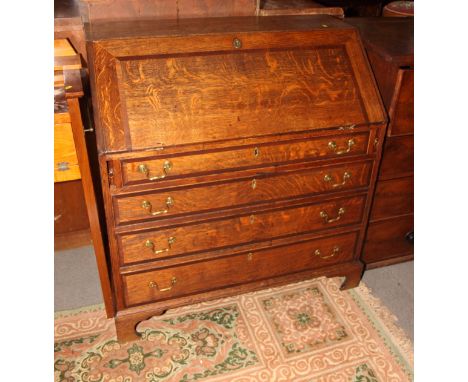 A Georgian oak and mahogany banded bureau, fitted four drawers, on bracket supports, 39" wide