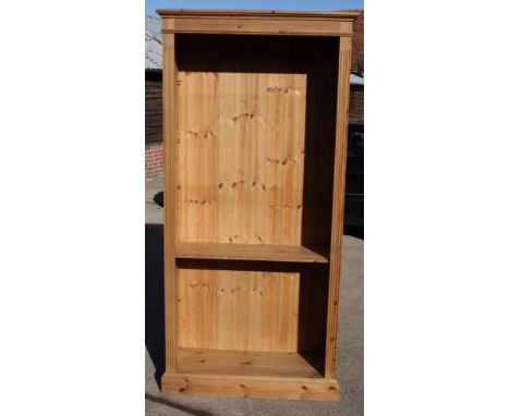 A waxed pine open bookcase, fitted four adjustable and one fixed shelf, on block base, 36" wide