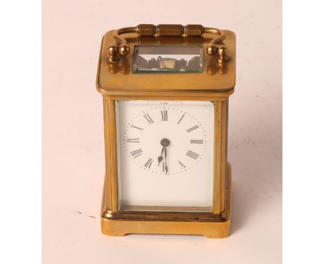 A brass cased carriage clock with white enamel dial