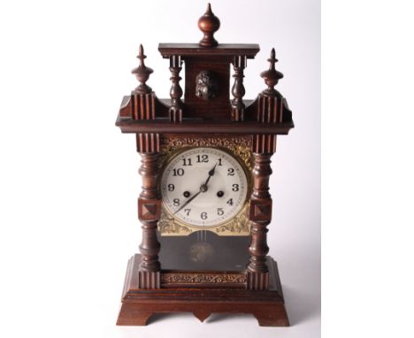 A late 19th Century mantel clock in dark stained wooden case decorated split turnings, 19" high, and a Smith's mantel clock i