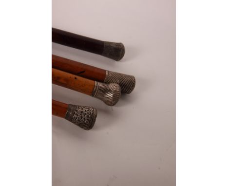 Three silver mounted Malacca walking sticks and a similar hardwood stick