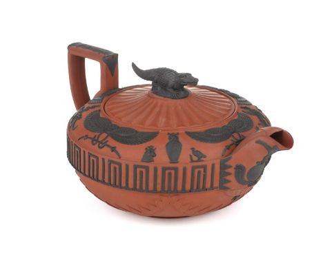 A large Wedgwood rosso antico teapot and cover, early 19th century, with applied Egyptian decoration, the cover with crocodil