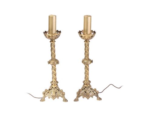 A pair of 19th-century "Ecclesiastic- Gothic" gilt brass table lamps with pierced cup drip pans above vine-wrapped "Solomonic