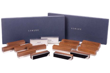 David Linley: two boxed sets of eight English walnut and silver plated rectangular name place stands with loaded bases. 9 cm 
