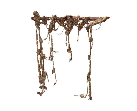 A Tibetan carved bone necromancer's apron, 19th century, carved with wrathful deities and auspicious symbols, united by beads