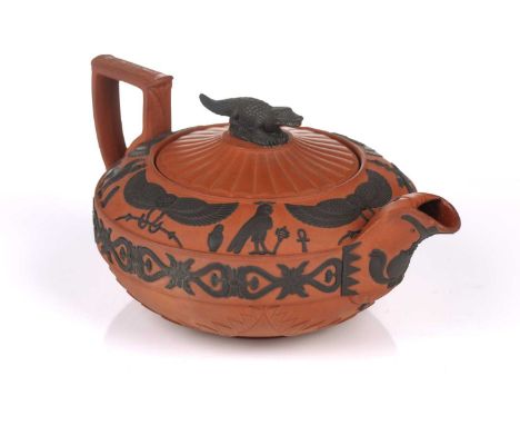 A Wedgwood rosso antico teapot and cover, early 19th century, with applied Egyptian decoration, the cover with crocodile fini
