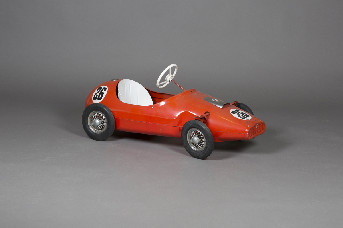 A 1960s Tri-ang pedal racing car, finished in red with race number 26 ...