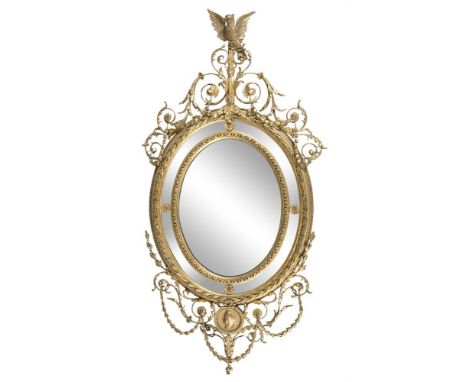 A PAIR OF 19TH CENTURY GEORGE III STYLE OVAL MIRRORS, the compartmented frames with bellflower banding surmounted by a figure