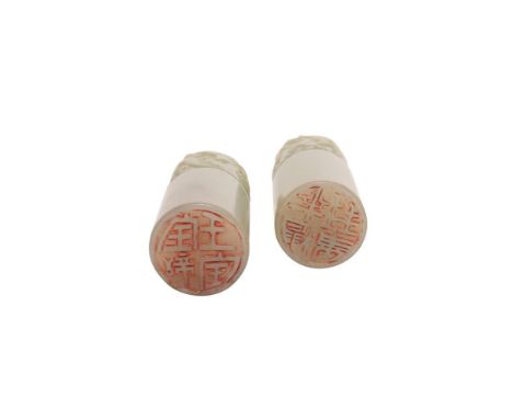 A PAIR OF PALE JADE 'DRAGON' SEALS, 19th century each carved on a cylindrical section with five-clawed dragons in coiled posi