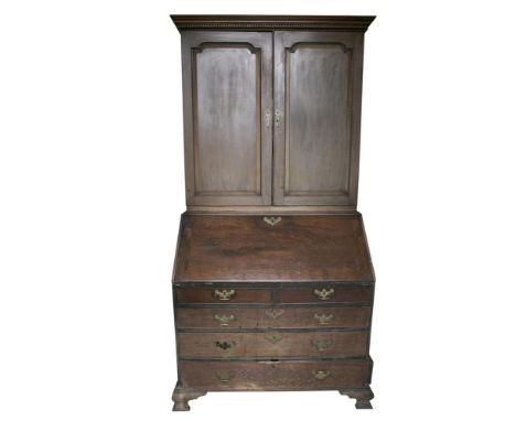 A MAHOGANY SLOPEFRONT BUREAU, c.1770, the slopefront revealing a fitted interior with centre panelled carved door, flanked by