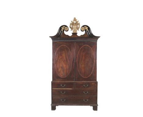 A GEORGE III MAHOGANY RECTANGULAR LINEN PRESS, the dentil cornice above two inlaid doors with oval panels enclosing 4 sliding
