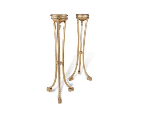 A PAIR OF FRENCH EMPIRE STYLE GILT TORCHERE STANDS, each circular top with moulded rim above a fluted band interposed with th