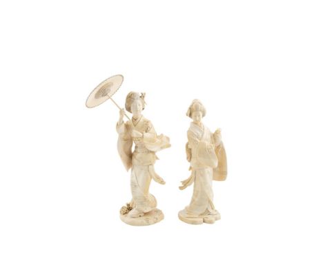 TWO JAPANESE IVORY OKIMONO, MEIJI PERIOD (1868 - 1912), one modelled as a lady standing holding a parasol above her head, dre