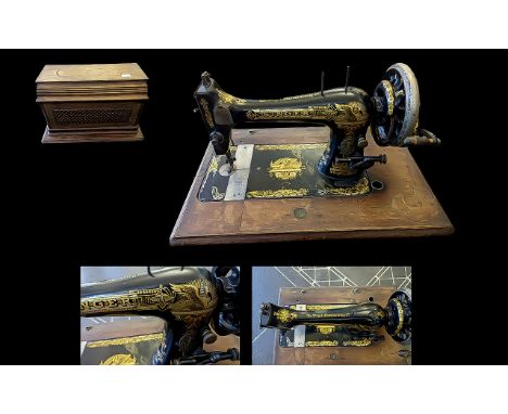 Vintage Singer Sewing Machine, black and gold colourway, in fitted wooden case.