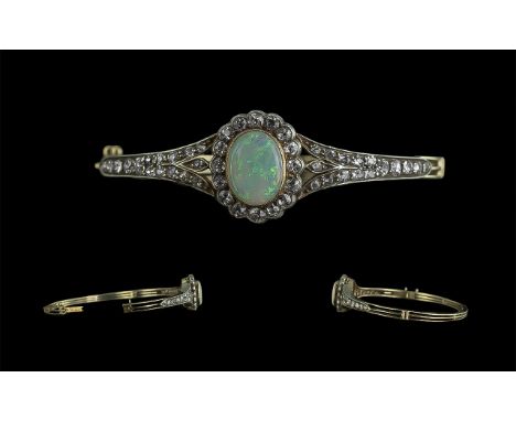 Antique Period Superb Quality 18ct Gold and Platinum Opal and Diamond Set Hinged Bangle, the central Australian opal of super