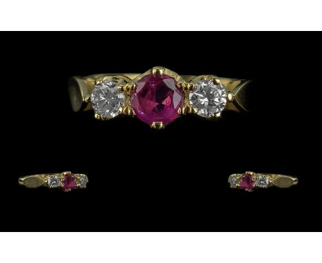 18ct yellow gold ruby and diamond 3 Stone ring. Central Ruby with a diamond each side. Round cut Ruby 0.58ct. Round brilliant