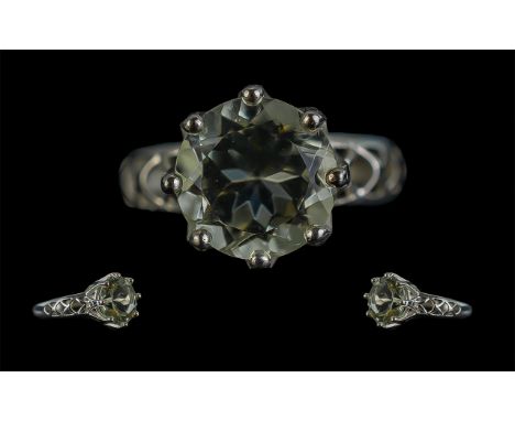 Green Amethyst Solitaire Ring, a 4.5ct round cut, soft mint green amethyst held in an eight claw, silver coronet setting, wit