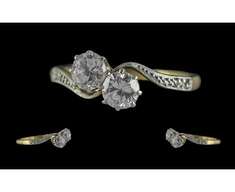 18ct Gold Attractive 2 Stone Diamond Set Twist Ring. Marked 18ct to Interior of Shank. The Two Round Old Brilliant Cut Diamon