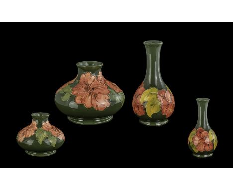 Two Small Moorcroft Vases, Coral Hibiscus Pattern, comprising a bud vase 6.5" high and a squat shaped vase 5" high.  Both in 