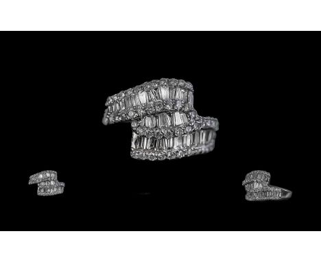 14ct White Gold Well Designed Brilliant & Baguette Cut Diamond Set Ring. Marked 585 to interior of shank. The diamonds are of