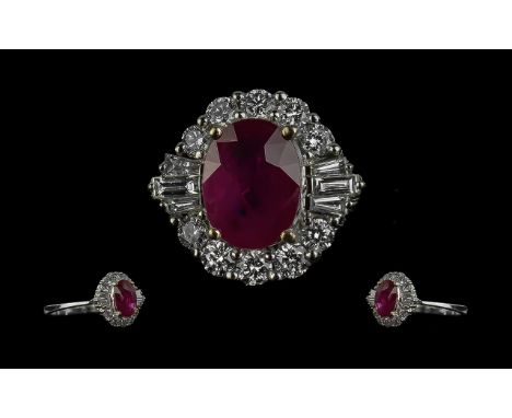 18ct White Gold Oval Ruby and Diamond Cluster Ring.  Central Ruby est. weight 1.27ct. surrounded by Round Brilliant Cut and b