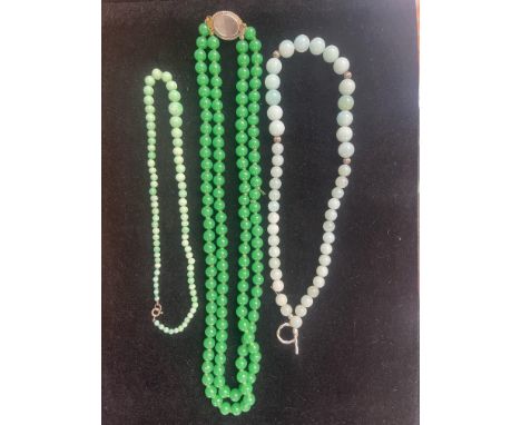 Double Row Green Jade Bead Necklace, of round beads plus an oval set to tongue and box clasp; 21.5 inches length of longer ro