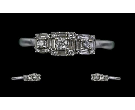 18ct White Gold Illiana Baguette And Brilliant Cut Diamond Set Dress Ring. The diamond is of excellent colour and clarity. Es