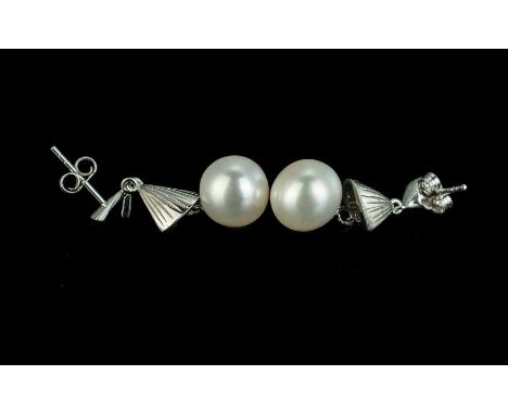 White Cultured Pearl Drop Earrings of elegant design, each large, ( approximately 10mm wide ), round, lustrous pearl suspende