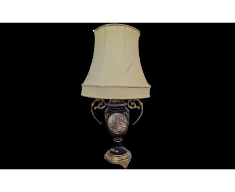 Classical Style Table Lamp, blue and gilt with central oval panel with an image of a courting couple.  Two decorative side ha