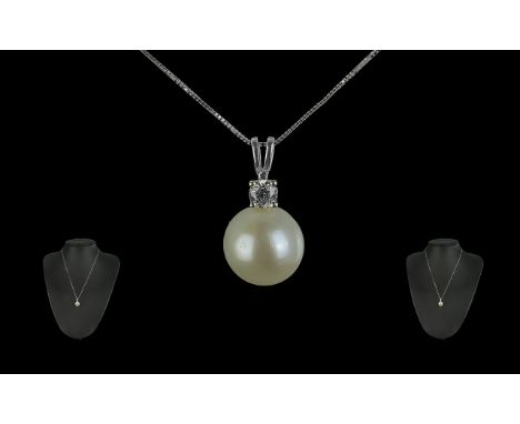 9ct White Gold Cultured Pearl and Diamond Bale Necklace. The round brilliant cut diamond weight 0.23ct.  Large pearl suspende