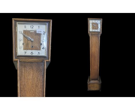 Kendall & Dent of London Granddaughter Clock, square column base with square face.  Measures 56" x 9" x 7.5".