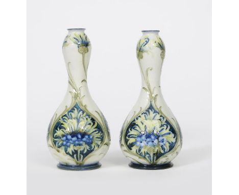 'Revived Cornflower' a pair of James Macintyre &amp; Co Florian Ware bottle vases designed by William Moorcroft,  ovoid with 