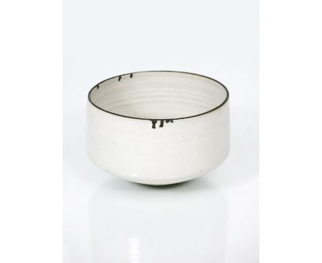 ‡ Dame Lucie Rie DBE (1902-1995) a stoneware bowl, tapering cylindrical form,  pitted grey glaze, the rim with bleeding manga