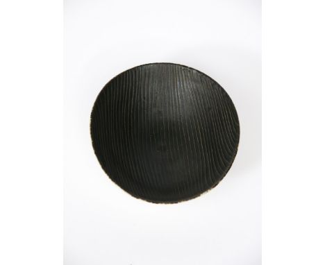 ‡ Dame Lucie Rie DBE (1902-1995) a small porcelain sgraffito dish, footed circular form with raised rims, the inside glazed m