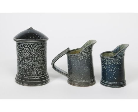 ‡ Walter Keeler (born 1942) a  salt-glazed stoneware angled pot and cover, covered in a blue and grey glaze, a Walter Keeler 