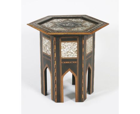 An Anglo-Moorish inlaid occasional table, possibly retailed by Liberty &amp; Co, hexagonal section on arched legs, inlaid wit
